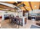 Open kitchen area with a stone-accented center island with barstool seating, stainless steel appliances, and wood ceiling at 139 W Jefferson St, Jamestown, IN 46147