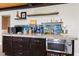 Kitchenette area with wood countertop, tile backsplash, stainless steel appliances and decorative shelving at 139 W Jefferson St, Jamestown, IN 46147