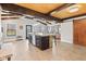 Spacious kitchen showcasing a large center island with stone accents, stainless steel appliances, and a wood-paneled ceiling at 139 W Jefferson St, Jamestown, IN 46147