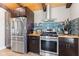 Modern kitchen featuring stainless steel appliances, tile backsplash, wood counters and plenty of cabinet space at 139 W Jefferson St, Jamestown, IN 46147
