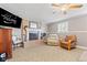 Inviting living room features a tile fireplace, neutral carpet, a ceiling fan, and large window with natural light at 139 W Jefferson St, Jamestown, IN 46147