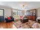 Bright and inviting living room with a large window, stylish furniture, and hardwood floors at 139 W Jefferson St, Jamestown, IN 46147
