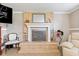 Charming living room showcases a tile fireplace, mirror, and neutral furniture, creating a relaxing space to unwind at 139 W Jefferson St, Jamestown, IN 46147