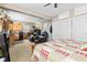View of a living space with a bed, recliners, a kitchenette with wood cabinets and a black safe at 139 W Jefferson St, Jamestown, IN 46147