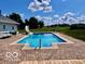 Inviting backyard pool with a slide, surrounded by a stylish patio and lush greenery at 139 W Jefferson St, Jamestown, IN 46147