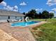 Backyard pool with slide, lounge chairs, and a charming patio, perfect for summer fun and relaxation at 139 W Jefferson St, Jamestown, IN 46147