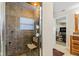 Shower stall with glass door, mosaic tiling, handrail and attached shower chair at 139 W Jefferson St, Jamestown, IN 46147