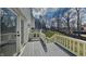 An expansive outdoor deck constructed with painted wood railings offers views of the lawn at 14402 Allison Dr, Carmel, IN 46033