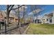 Large grassy backyard, bordered by black metal fence, features mature trees at 14402 Allison Dr, Carmel, IN 46033