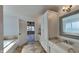 Bright bathroom with a large vanity, mirror, and ample storage space and a tile floor at 14402 Allison Dr, Carmel, IN 46033