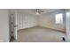 Bright carpeted bedroom featuring a window, ceiling fan, and closet with bifold doors at 14402 Allison Dr, Carmel, IN 46033