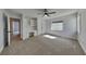 Bright carpeted bedroom with a ceiling fan, built in desk and shelves, and window at 14402 Allison Dr, Carmel, IN 46033