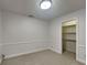 Carpeted bedroom with built-in shelving in a closet and neutral colored walls and trim at 14402 Allison Dr, Carmel, IN 46033