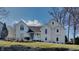 Charming two-story white home featuring an inviting front yard landscape and architectural details at 14402 Allison Dr, Carmel, IN 46033