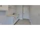 Functional laundry room with utility sink, ample storage, and neutral decor at 14402 Allison Dr, Carmel, IN 46033