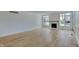 Spacious open-plan living room with light hardwood flooring and a cozy fireplace area at 14402 Allison Dr, Carmel, IN 46033