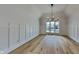 Bright living room boasts beautiful hardwood floors, crown molding, and a statement chandelier at 14402 Allison Dr, Carmel, IN 46033