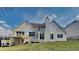 Rear exterior shows multilevel deck, brick chimney, and gabled roofline, surrounded by lawn at 14402 Allison Dr, Carmel, IN 46033