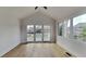 Bright sunroom with vaulted ceiling, hardwood floors, and sliding glass doors to an outdoor deck at 14402 Allison Dr, Carmel, IN 46033