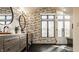 Elegant bathroom showcasing wood cabinets, black hexagon floors, large windows and a glass shower at 1448 Sedona Dr, Carmel, IN 46032