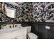 Stylish powder room with floral wallpaper, round mirror, and modern vanity at 1448 Sedona Dr, Carmel, IN 46032