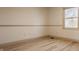 Bedroom featuring a bright window letting in natural light and light colored hardwood flooring at 1448 Sedona Dr, Carmel, IN 46032