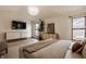 Spacious bedroom with a modern entertainment center, bright windows, and comfortable furnishings at 1448 Sedona Dr, Carmel, IN 46032