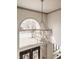 Elegant chandelier hangs above the entryway with a large arch window offering a view of the green front yard at 1448 Sedona Dr, Carmel, IN 46032