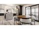 Open concept kitchen and dining area features light wood floors and stainless steel appliances with seamless flow at 1448 Sedona Dr, Carmel, IN 46032