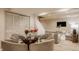 Dining area with glass table, seating for four, stylish decor, and an open concept to a living area at 1448 Sedona Dr, Carmel, IN 46032