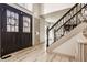 Inviting entryway featuring a modern staircase, sleek floors, and abundant natural light at 1448 Sedona Dr, Carmel, IN 46032