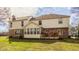 Back exterior view featuring a multi-level deck, brick facade, and well-maintained lawn at 1448 Sedona Dr, Carmel, IN 46032