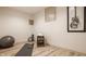 Home gym featuring yoga mat, weights, exercise ball, and modern decor on laminate flooring at 1448 Sedona Dr, Carmel, IN 46032