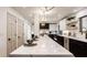 Large kitchen island with white countertops, sleek cabinets, and modern pendant lighting at 1448 Sedona Dr, Carmel, IN 46032