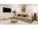 Bright living room with large sofa, decorative pillows, round coffee table, rug, and stylish decor at 1448 Sedona Dr, Carmel, IN 46032