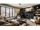 Cozy living room features a black brick fireplace, custom built-ins, and large window for natural light at 1448 Sedona Dr, Carmel, IN 46032