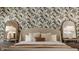 A close up of the main bedroom showcasing wallpaper accent, warm color bedding and decorative pillows at 1448 Sedona Dr, Carmel, IN 46032