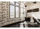 Luxurious glass enclosed shower with modern fixtures, black hexagon tile, and natural light from a large window at 1448 Sedona Dr, Carmel, IN 46032
