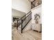 Elegant staircase with black iron railings and a view of the dining area at 1448 Sedona Dr, Carmel, IN 46032