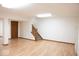 Finished basement with laminate flooring, neutral color palette, and walkout access at 14573 Waverly Dr, Carmel, IN 46033