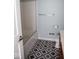 Neutral bathroom with a shower/tub combo, designer tile, and a wooden vanity at 14573 Waverly Dr, Carmel, IN 46033