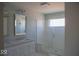 This bathroom is complete with a glass shower, white cabinets, and a double sink at 14573 Waverly Dr, Carmel, IN 46033