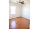 This bedroom features hardwood flooring, a window, and a ceiling fan at 14573 Waverly Dr, Carmel, IN 46033