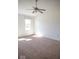 Bright bedroom features neutral carpet, white walls, a window, and a ceiling fan at 14573 Waverly Dr, Carmel, IN 46033