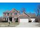 Charming two-story brick home with attached two car garage and well-manicured landscaping at 14573 Waverly Dr, Carmel, IN 46033