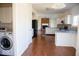 Bright kitchen featuring white cabinets, stainless steel appliances, and hardwood flooring at 14573 Waverly Dr, Carmel, IN 46033