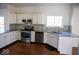 Beautiful kitchen with stainless steel appliances, tile backsplash, granite countertops, and wood floors at 14573 Waverly Dr, Carmel, IN 46033