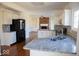 Modern kitchen boasts granite countertops, stainless steel appliances, and open floor plan at 14573 Waverly Dr, Carmel, IN 46033