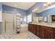 Bathroom featuring dual sinks, a soaking tub, a shower, and blue painted walls at 15254 Kampen Cir, Carmel, IN 46033