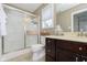 Bathroom featuring a sliding glass door shower, wood cabinets, and a beige countertop at 15254 Kampen Cir, Carmel, IN 46033